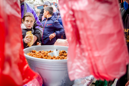 Belo Blato, Vojvodina, Serbia - February 10, 2018: Selling pork crackling on outdoor stand, cellophane plastic bags are hanging in bunch.のeditorial素材