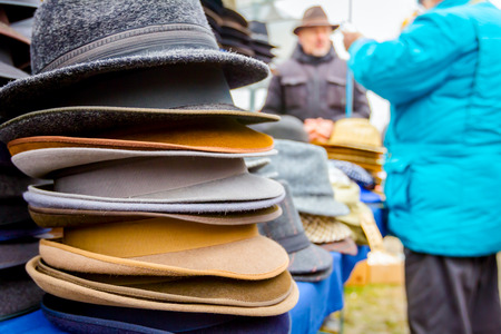 Stacked various colored men hats for sale, available at flea market.の写真素材