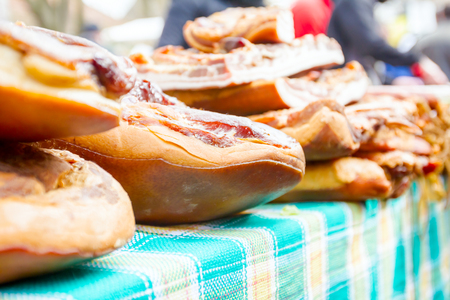 Bunch of cured bacon, meat for sale at outdoor flea market.の写真素材
