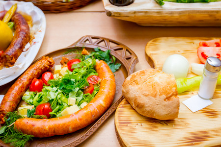 Decorated sausages with fresh vegetables are exposed on traditional sausage tournament.の写真素材