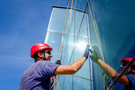 Closeup  view on smears silicone on joints between windows with forefinger.