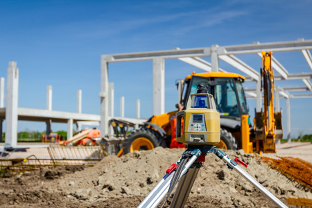 Total center device with laser for leveling other devices to level construction site.の写真素材