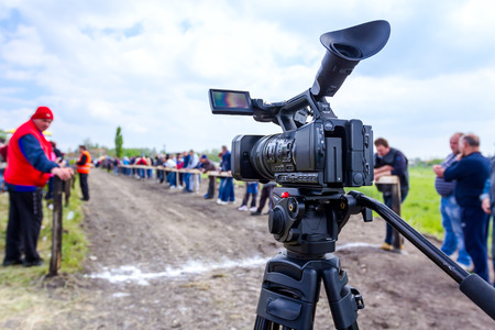 Chestereg, Vojvodina, Serbia - April 30, 2017: Modern camera is standing on tripod at finish line.のeditorial素材