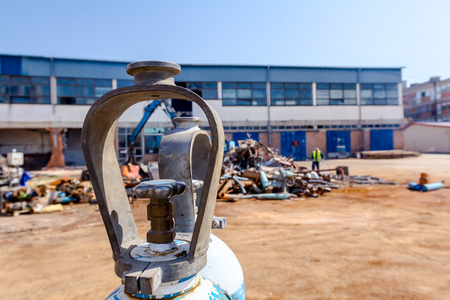 Welding gas tank, for cutting scrap metal with acetylene torch at junkyard.の写真素材