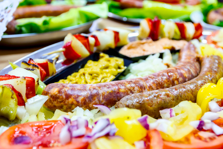 Decorated sausages with fresh vegetables are exposed on traditional sausage tournament.の写真素材