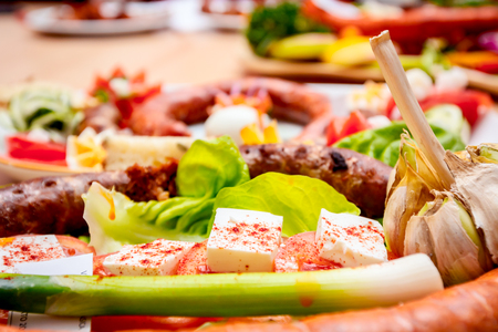 Decorated sausages with fresh vegetables and cheese are exposed on traditional sausage tournament.の写真素材