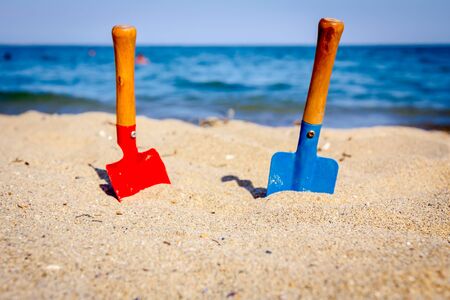 Small spade and shovel for digging sand on the beach.の写真素材