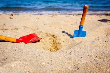 Small spade and shovel for digging sand on the beach.の写真素材