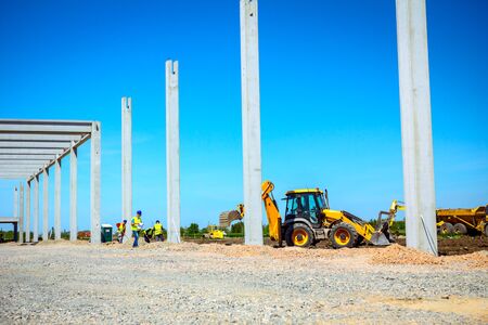 Big excavator is excavating soil at construction site, project in progress.の写真素材