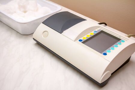 Modern machine with display for recording ECG or EKG over electrodes, sensors for electrocardiogram...