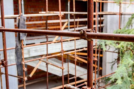 Scaffold is placed against edifice, building under construction.の写真素材