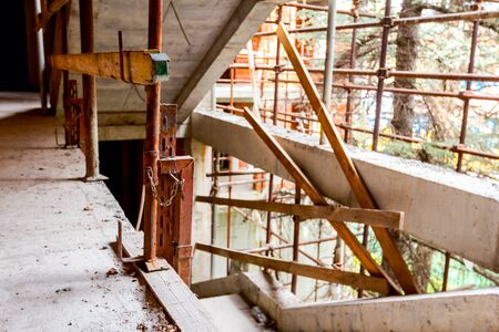 Clamp of improvised safety stairway fence in building under construction.