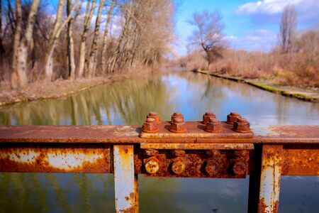 Detail of steel construction with old rusty screws on the fence of the bridge.の写真素材