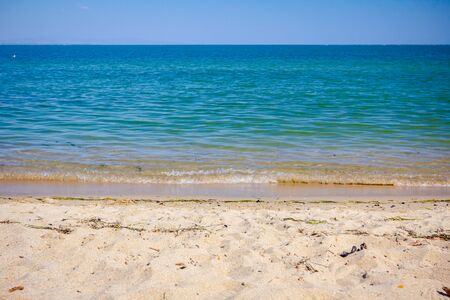 Scenic view is on the sandy beach and beautiful horizon over the sea.の写真素材