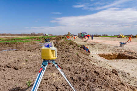 Total center device with laser for leveling other devices to level construction site.の写真素材