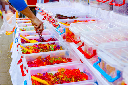 Various colored candies and sweets for sale placed in trays, available at flea market.の写真素材