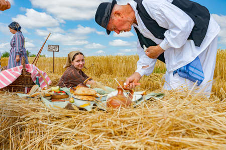 Muzlja, Vojvodina, Serbia, - July 03, 2021; XXXVIII Traditionally wheat harvest. Elderly man and...