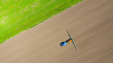 Above top view, overhead view on tractor until spraying big endless farmland dragging mounted wide...
