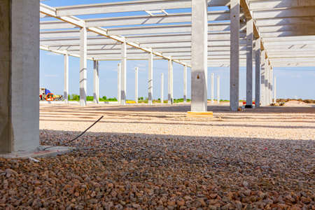 Concrete joists, are assembled into skeleton of unfinished construction of huge edifice.