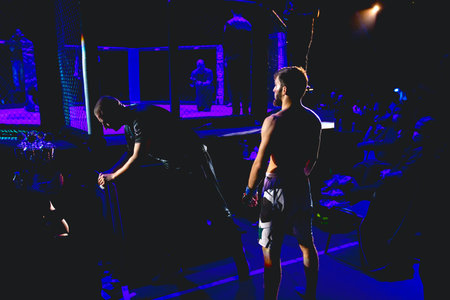 Judge taking last review of MMA competitor, fighter before it enters in arena, ring octagon, for...