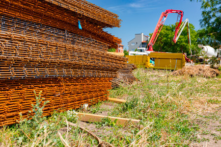 Pile of rusty rectangle steel reinforcement for concrete ready for installation placed at construction site.の写真素材