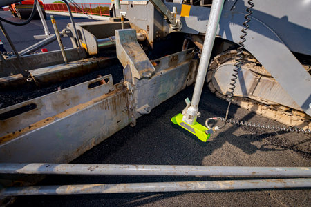 Road laying construction machine with ultrasonic grade, slope, non-contact sensor, (multiplex)...