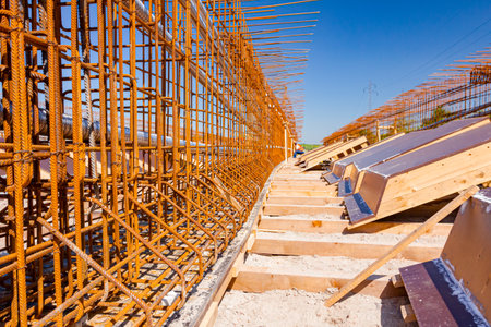 Girder, bridge skeleton, reinforcement, installed vertical crossed rusty armature rods and pile of...