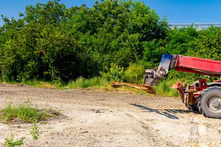 Forklift machinery for delivery and transport is lifting up selected bundle of rusty armature from...