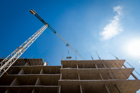Concrete skeleton of new unfinished multi-storey building, residential complex under construction,...