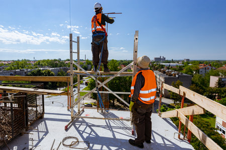 Supervisor, foreman look out on worker tying armature to make a reinforcing frame for concrete...