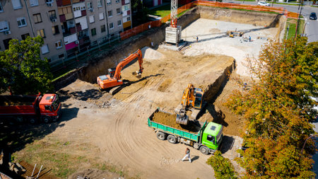 Above view on two big excavators as they digging, excavating foundation for new residential building...