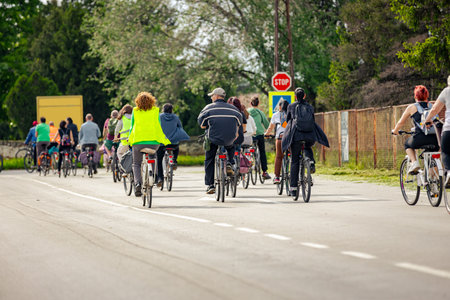 Group of young people cycling, ride bicycles in city, they try to draw attention to the danger for...