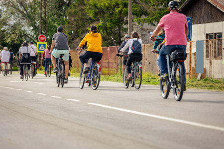 Group of young people cycling, ride bicycles in city, driving in crowd they try to draw attention to...