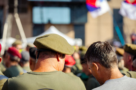 Belgrade, Serbia - June 28, 2025: Group of war veterans with berets at student's protest against...