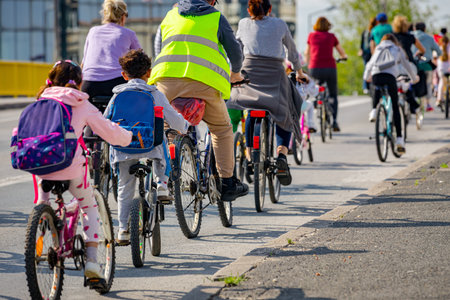 Children are cycling with a group of people in the city, riding bicycles and trying to draw...