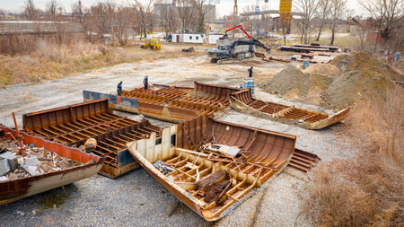 Above view on workers as they cutting parts of old large vessel into smaller pieces, barge, dismantling ship, cut out rusty metal for scarp, using acetylene torch, recycling, sparks are fly around.の写真素材
