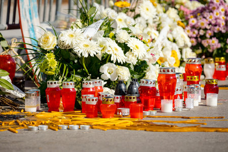 Memorial candles and flowers at the place where tragic accident happened, canopy collapse at railway station. Commemorative gathering, collective grief, remembrance and solidarity for lost 16 livesの写真素材