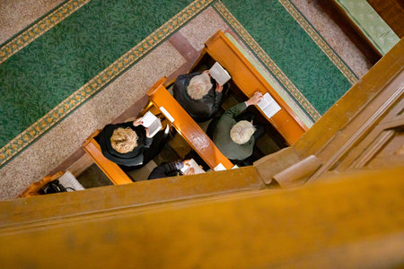 Above view on believers as praying with their priest at Sunday morning in old and small stylish...