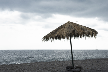 Single beach umbrella on a background of the ocean.の写真素材