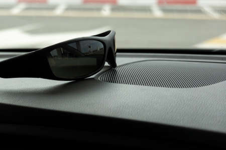 Interior of the car from the inside. On the front panel are sun glasses for the driver. Concept:...