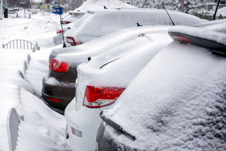 The snow-covered Parking lot with cars. Selective focus.の写真素材