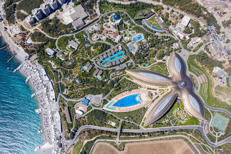 Crimea, Yalta, August 8, 2020: Mriya health resort complex on the beach. The coastline is equipped with piers, sun beds and umbrellas. Shooting from the air.のeditorial素材