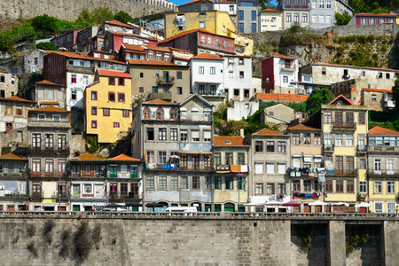 Colorful facades of old houses with clothes hanging on a rope on the banks of the Douro River in Porto.の写真素材