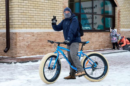 Russia, Naberezhnye Chelny, February 13, 2020: urban winter landscape. A positive adult man on a fat...