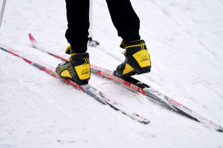 Russia, Naberezhnye Chelny, February 13, 2021: fragment of a cross-country skier in motion: skis, legs, boots.のeditorial素材