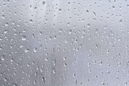 Frosts after the thaw. Frozen water drops on the glass. Macro. Texture.の写真素材