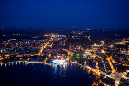 Top view of the night city of Porec in Croatia. Aerial photography.の写真素材