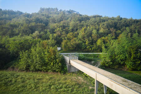 An unfinished, abandoned viaduct, the entrance to which is closed by a grid. Shooting from a drone.