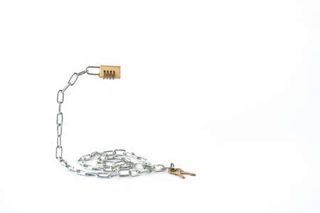A metal chain with a combination lock on one end and keys on the other end. Selective focus. Copy space.の写真素材