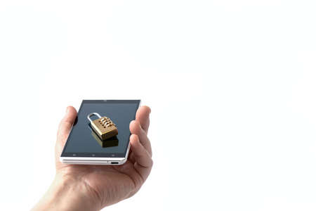 A man's hand holds a smartphone with a combination lock on it. Selective focus. Copy space.の写真素材